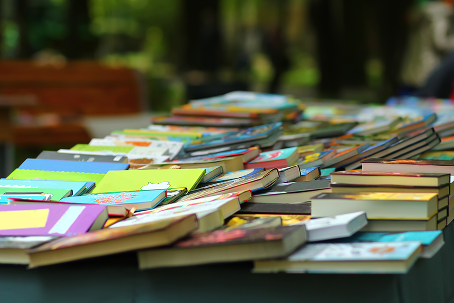 Books spread out on a table during pop up library event